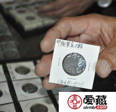 图为刘先生在展示印度古钱币